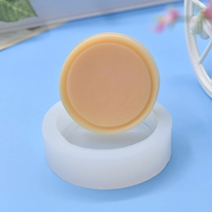 Round silicone baking mold for DIY cakes and chocolates on a light blue background