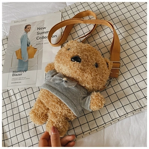Detail of cute caramel teddy bear plush crossbody bag with grey bow and mustard strap