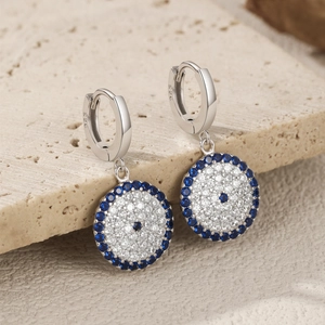Elegant 925 sterling silver hoop earrings with blue and white evil eye pattern charms