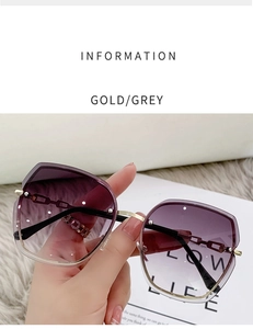 Detail view of gold rimless sunglasses with grey gradient lenses and diamond accents