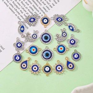 Detailed view of evil eye charms in sun, moon, and heart shapes for DIY jewelry making