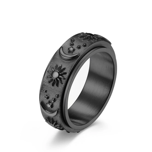Black stainless steel spinner ring featuring celestial sun moon and star engravings