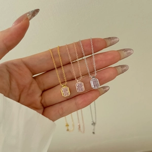Detailed view of three rectangular pink zircon pendants in gold silver and rose gold finishes