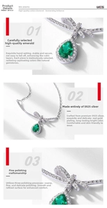 Detail of S925 silver necklace with bow design and emerald green pear shaped pendant