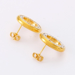 Minimalist gold hollow circular stud earrings with inset cubic zirconia on white background