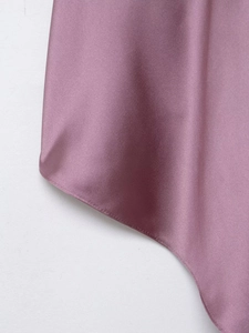 Detailed close-up of dark pink satin fabric showing elegant silk texture and stitching