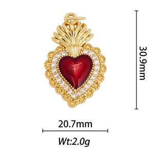 Detail view of sacred heart pendant with red gem and 30.9mm by 20.7mm size measurements