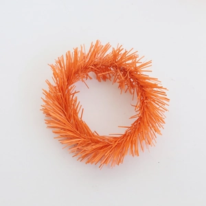 Macro shot of fluffy orange foil candle ring for Christmas wreath table decorations