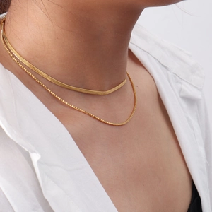 Detail of layered gold double chain featuring a sleek snake chain and delicate box chain