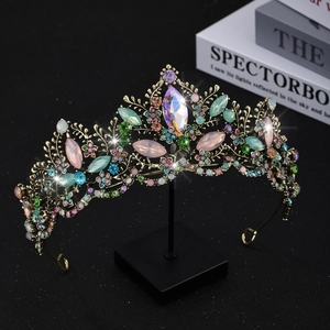 Detailed close-up of intricate gold alloy vines and colorful crystals on bridal crown