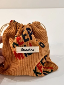 Corduroy drawstring storage bag in camel brown with colorful letter print for jewelry