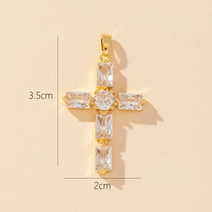 Detail view of a 3.5cm by 2cm gold-plated cross pendant set with clear zircon stones