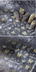 Macro detail of bronzing nail stickers with butterfly and lily floral patterns