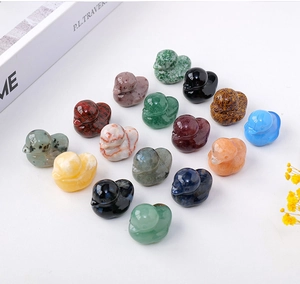 Detailed overhead view of fifteen colorful carved crystal duck figurines on white background