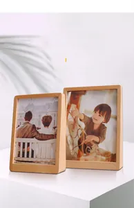 Detailed view of two vertical trapezoidal beech wood picture frames in natural finish