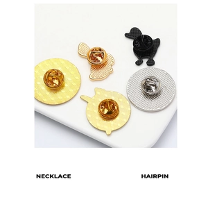 Detail of enamel pin backs showing butterfly clutches and metal plating finishes