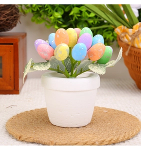 Detailed view of 12cm Easter egg plant with pastel spotted eggs in a white ceramic pot