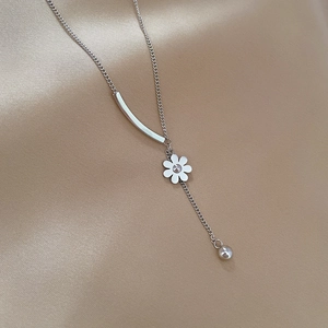 Detailed view of titanium steel floral necklace with silver curved bar and bead pendant