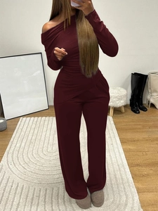 Detail of wine red two-piece set featuring off-shoulder long sleeve top and wide-leg pants