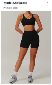 Premium black yoga set with cross back sports bra and high-waisted shorts on model