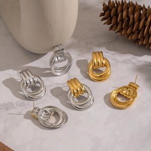Detail of minimalist geometric layered hoop earrings in gold and silver stainless steel
