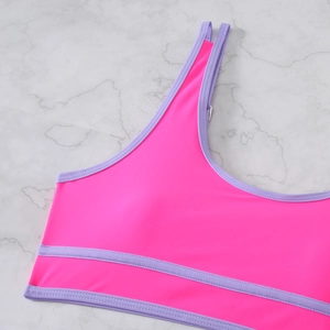 Detail of rose pink bikini top with lavender trim and metallic adjustment hardware