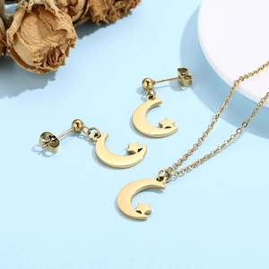 Detailed view of gold moon and star jewelry set featuring necklace and stud earrings