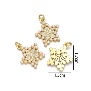 Detail view of gold star charms with micro-pave crystals and pearls for jewelry making