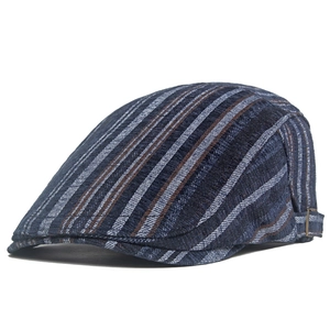 Close-up of navy striped newsboy cap featuring a vintage bronze metal adjustable buckle