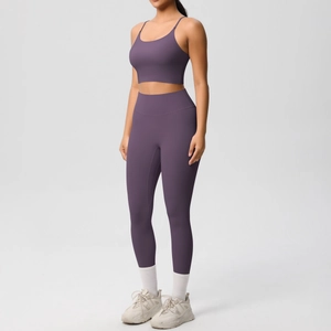 Close-up of seamless dark purple yoga set with high waist leggings and racerback sports bra