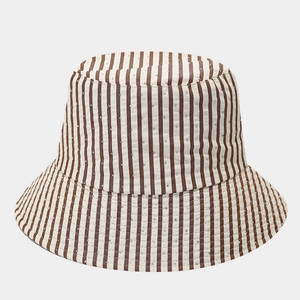 Detailed macro view of striped bucket hat featuring delicate rhinestone embellishments