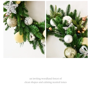 Detail of Christmas wreath with faux pine needles, silver stars, and warm LED lights
