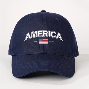 Detailed close-up of America 1776 embroidery on navy blue cotton twill baseball cap
