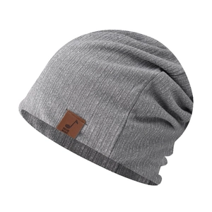 Close-up of grey ribbed knit beanie with brown leather HAVE MUSIC patch and soft texture