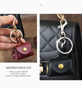 Close-up of red and black leather mini bag charms with vintage metal keychains