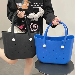 Detailed view of black and blue EVA beach tote bags with circular ventilation holes
