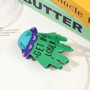 Close-up of green acrylic UFO hair claw clip with GET IN LOSER text and heart details