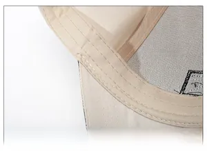 Close-up of the beige baseball cap's inner sweatband featuring precise double stitching