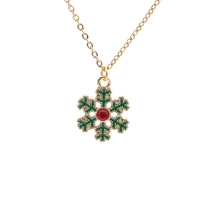 Christmas gold necklace set with green enamel snowflake pendant and red gemstone detail
