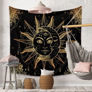 Detail of bohemian sun and moon tapestry hanging on a textured wall in a cozy room decor