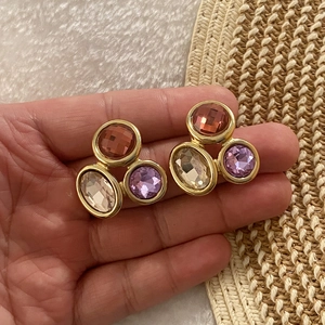 Luxury geometric gemstone stud earrings in red, champagne, and purple tones