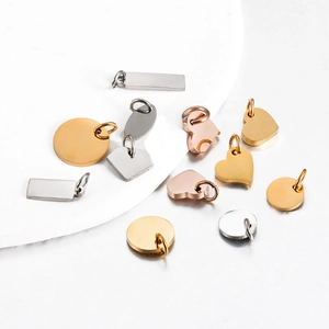Assorted polished stainless steel pendants in heart, round, and rectangle shapes
