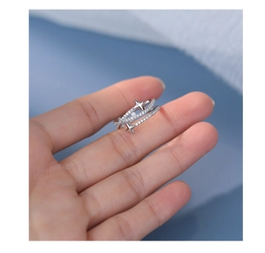 Close-up of a silver four-point star adjustable ring with sparkling zircon stones