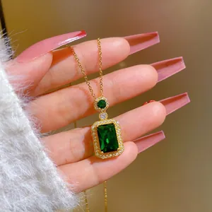 Macro shot of a luxury emerald cut green crystal pendant necklace with micro-inlaid diamonds
