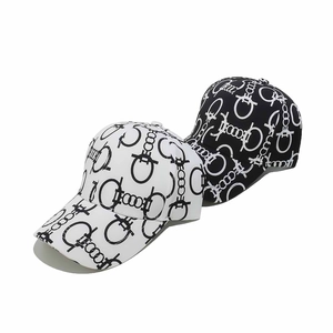 Detail of baseball caps with interlocking buckle prints in black and white colors