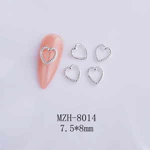 Detail view of 7.5x8mm hollow heart nail art charms in silver finish with beaded edges