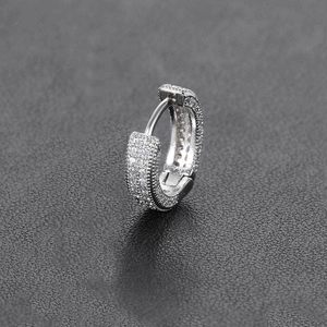 Macro shot of silver C-shape hoop earring featuring meticulously micro-paved cubic zirconia