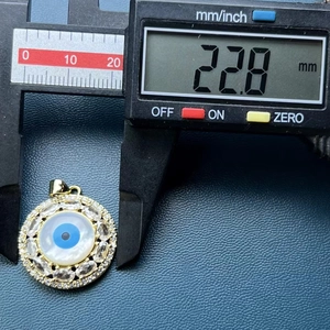 Macro shot showing evil eye shell pendant diameter of 22.8mm using digital calipers