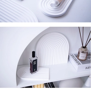 Detailed view of white wavy plaster storage tray and arched decorative backdrop props