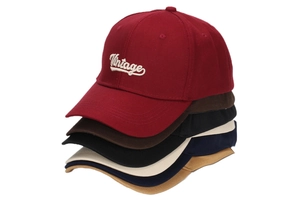 Detailed stack of six vintage embroidered cotton baseball caps in various colors